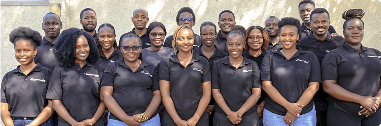 A group of BrighterMonday employees sitting and standing together in two rows, wearing a mix of red, black, and white branded t-shirts, posing inside a room. Above them, text reads: 'Discover Your Future with BrighterMonday. Be a part of the BrighterMonday Crew.' with a button below that says 'Explore careers.'